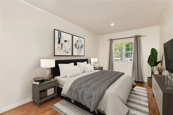 a bedroom with a bed and a painting on the wall