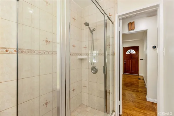 a bathroom with a shower and a glass door