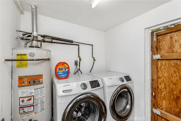 a view of storage and utility room with washer and dryer
