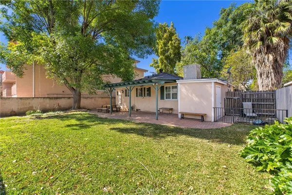 a view of a backyard with swimming pool