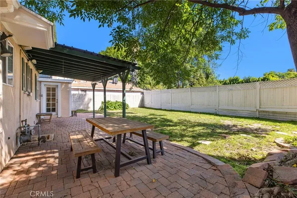 a view of a house with backyard and sitting area