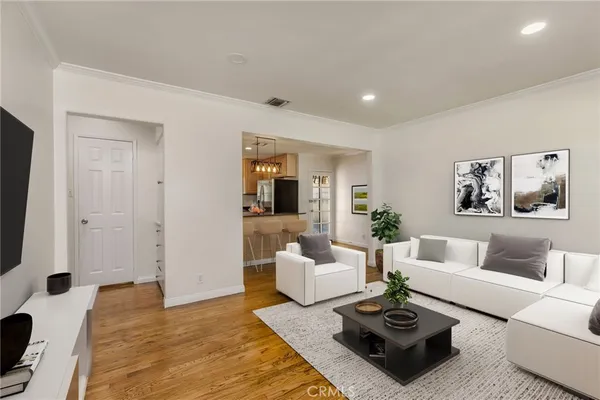 a living room with furniture a rug and a flat screen tv