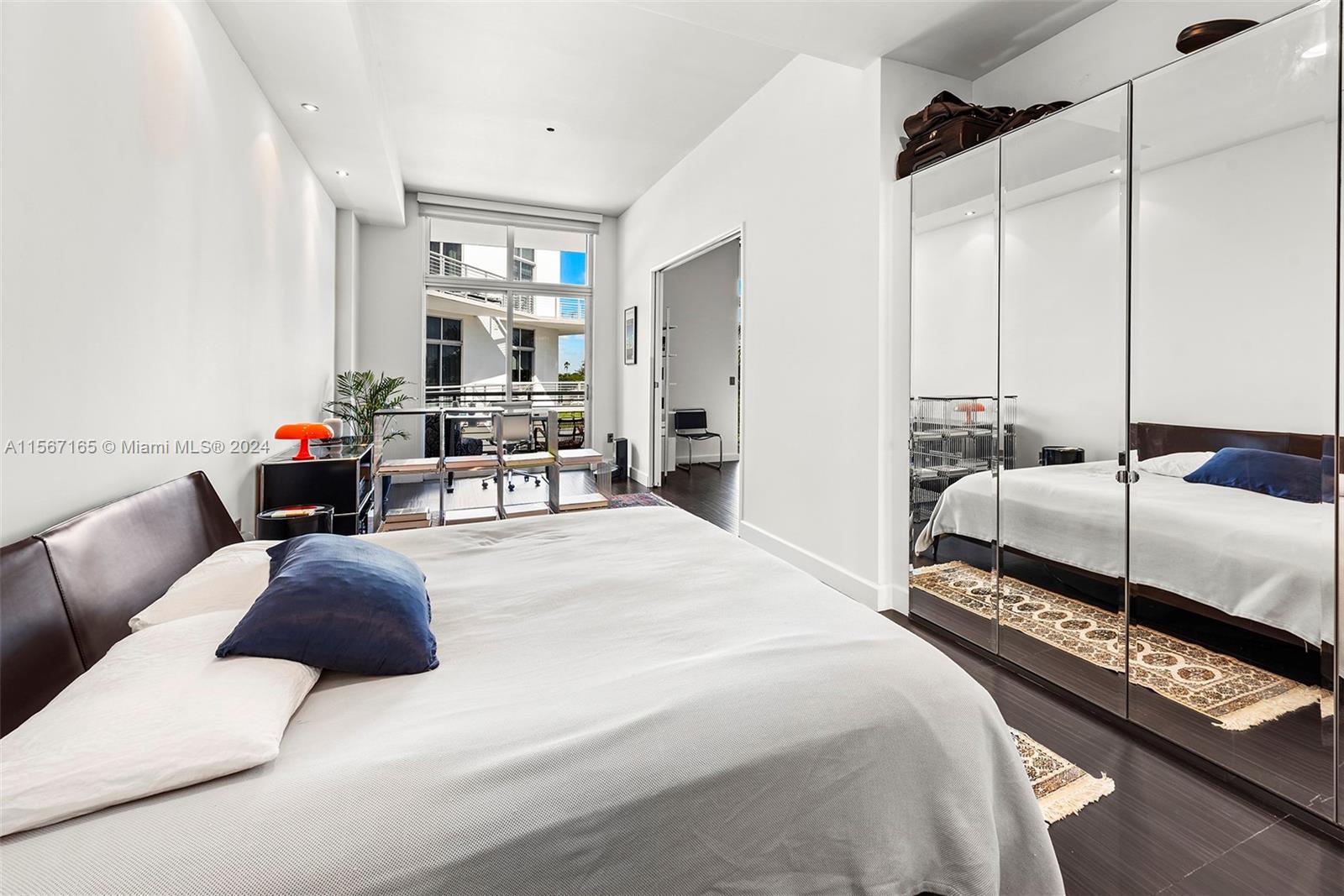 2001 Meridian Avenue, Unit 517 Miami Beach, FL 33139 - Photo 16 of 28 a bedroom with a bed and wooden floor