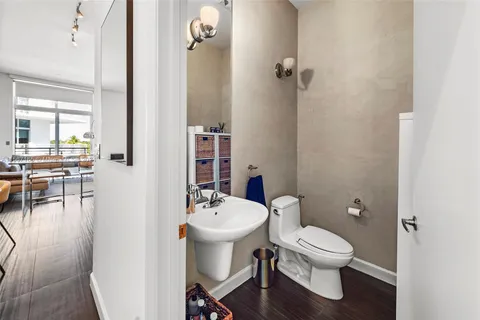 a bathroom with a toilet sink and mirror