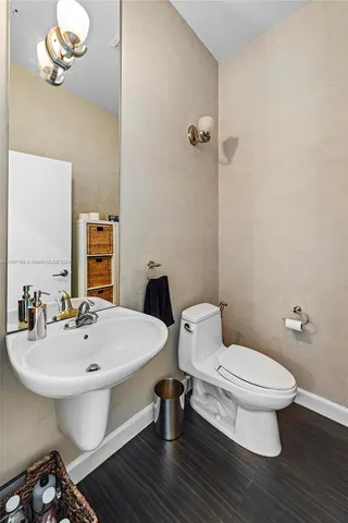 a bathroom with a sink a toilet and a mirror