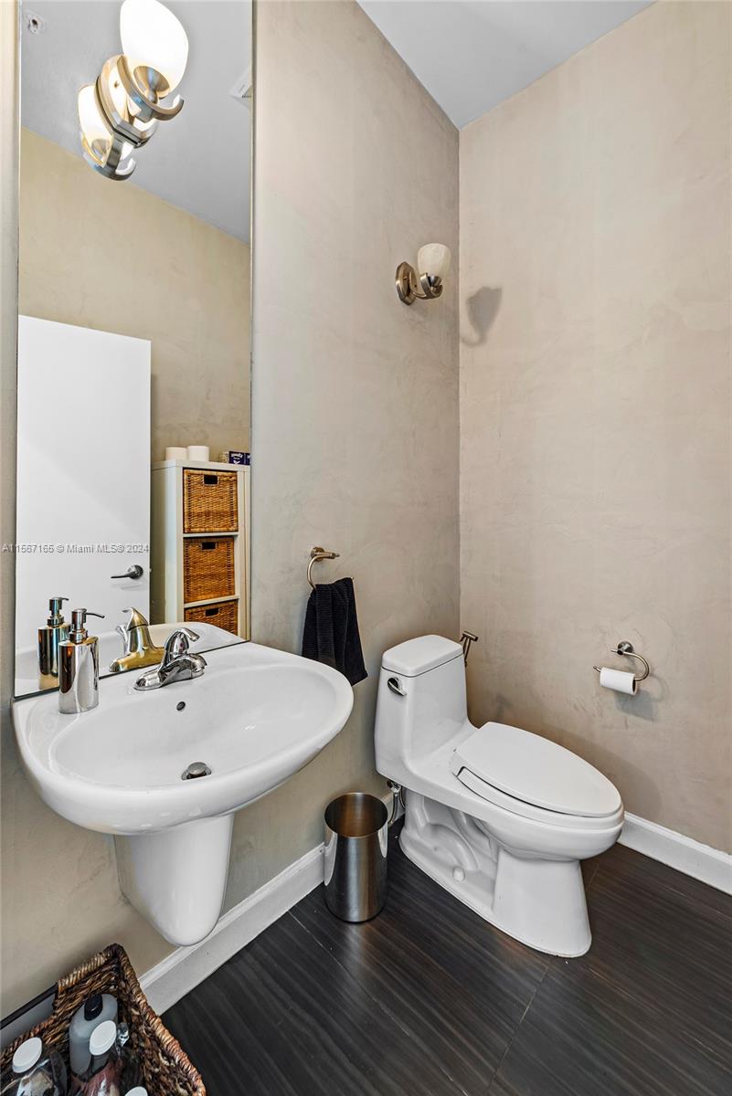 2001 Meridian Avenue, Unit 517 Miami Beach, FL 33139 - Photo 21 of 28 a bathroom with a sink a toilet and a mirror