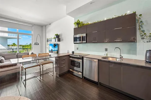 a kitchen with stainless steel appliances a sink and a stove