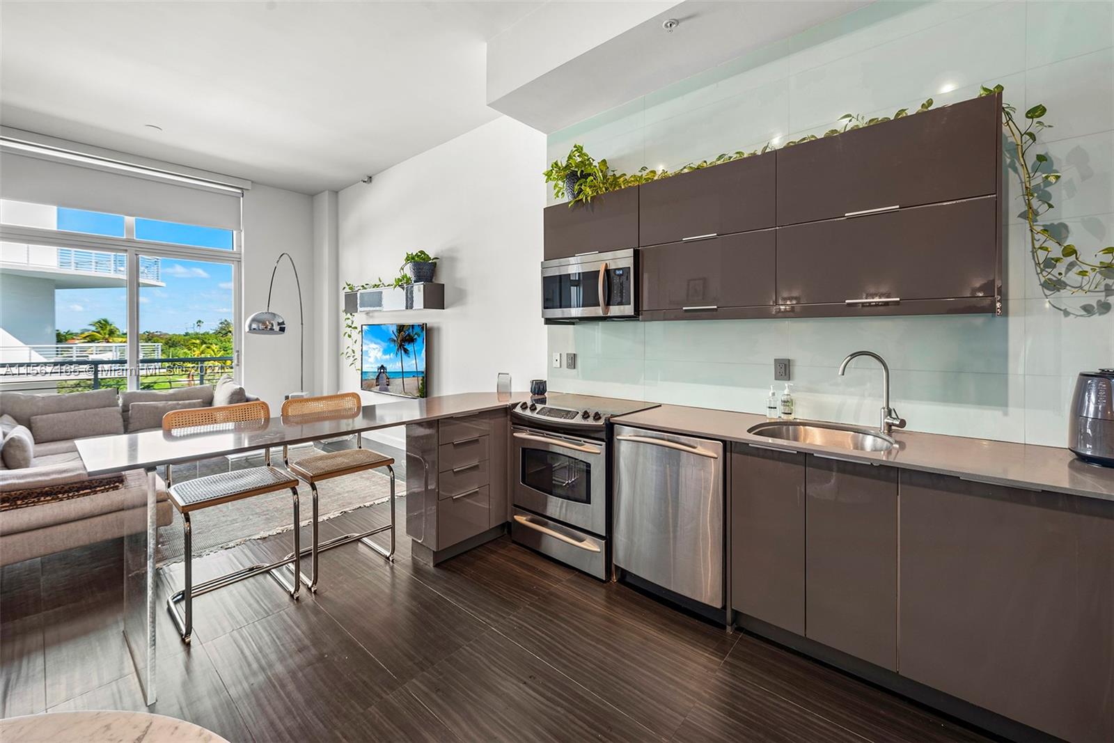 2001 Meridian Avenue, Unit 517 Miami Beach, FL 33139 - Photo 4 of 28 a kitchen with stainless steel appliances a sink and a stove