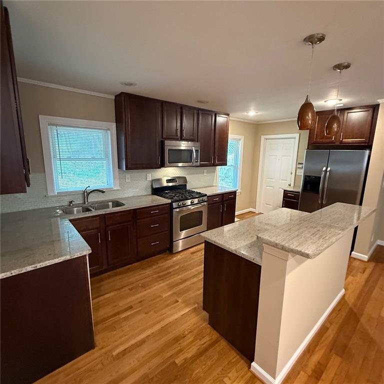 986 Biltmore Drive Northeast Atlanta, GA 30329 - Photo 2 of 9 a kitchen with stainless steel appliances kitchen island granite countertop a sink a stove and a refrigerator