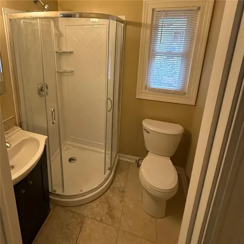a bathroom with a toilet and shower