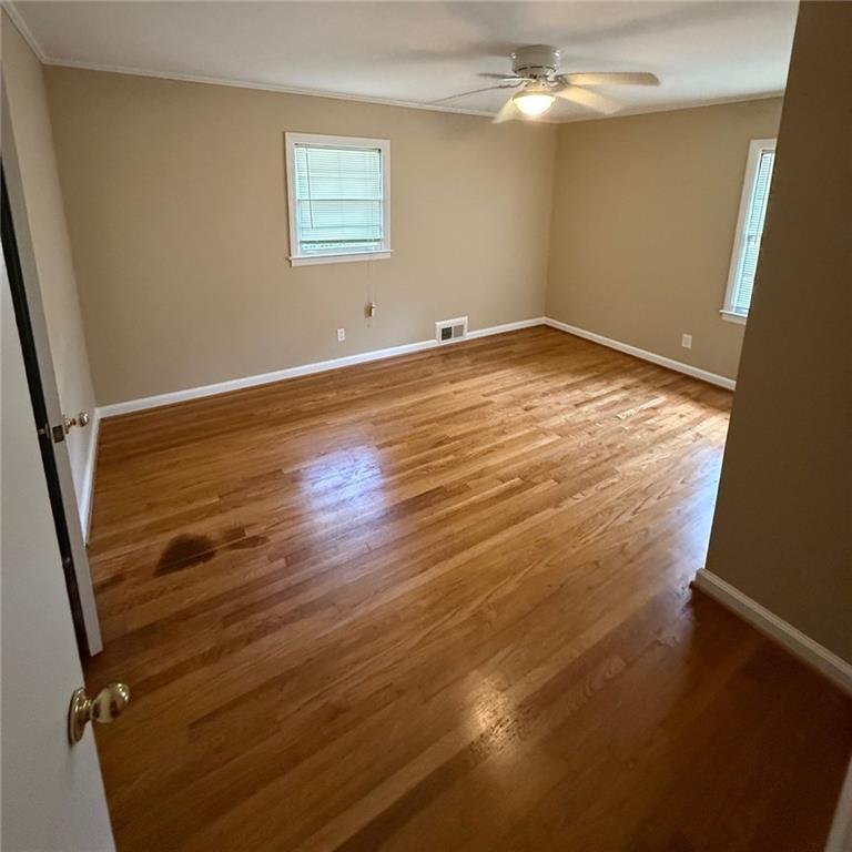 986 Biltmore Drive Northeast Atlanta, GA 30329 - Photo 6 of 9 an empty room with wooden floor and fan