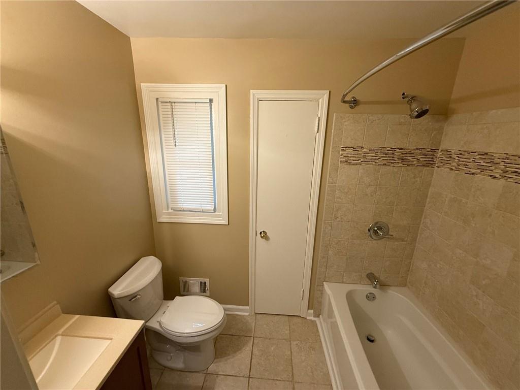 986 Biltmore Drive Northeast Atlanta, GA 30329 - Photo 7 of 9 a bathroom with a granite countertop toilet sink and shower