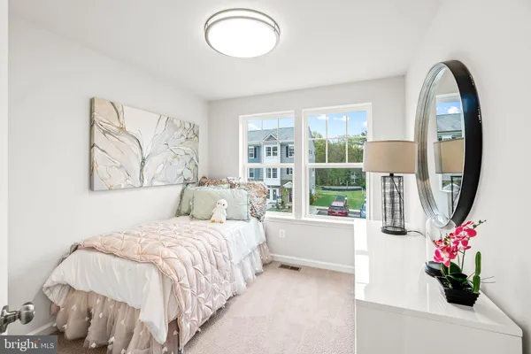 a bedroom with a bed and a large window