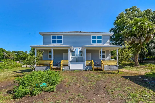 a front view of a house with outdoor seating