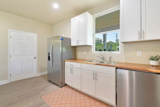 a kitchen with stainless steel appliances granite countertop a refrigerator sink and cabinets