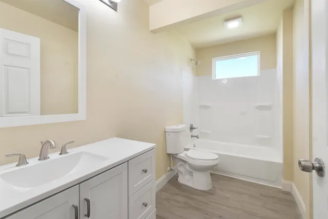a bathroom with a sink toilet and a mirror