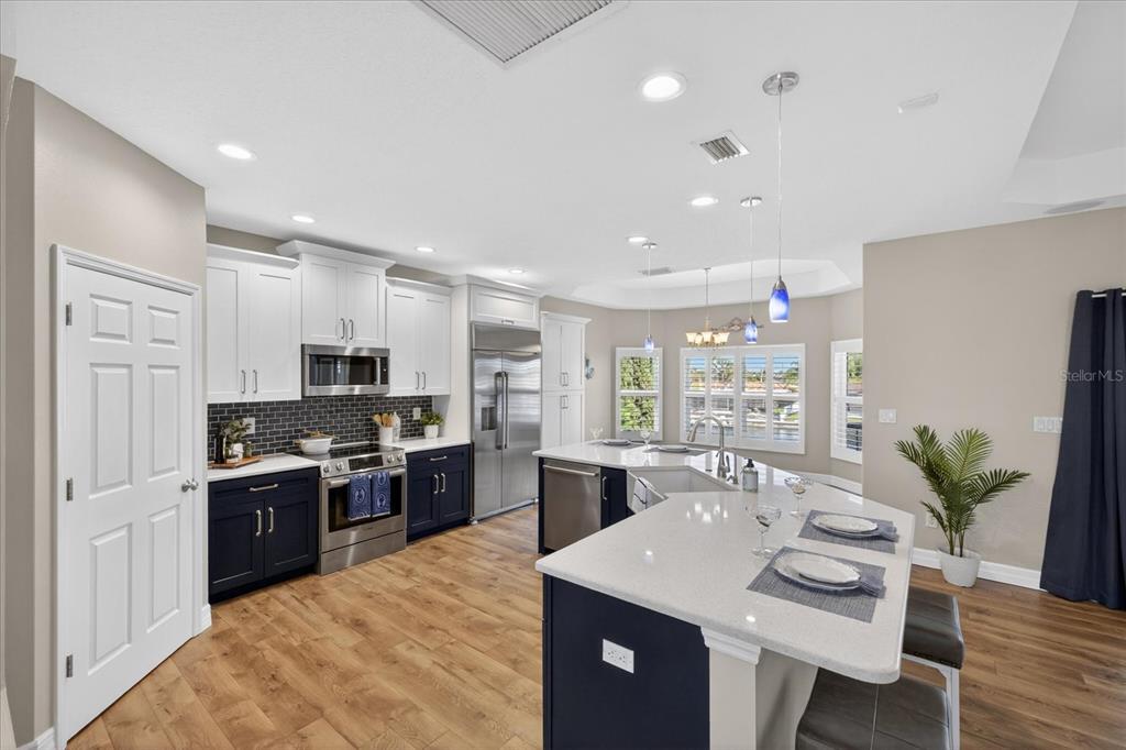 3339 Seaway Drive New Port Richey, FL 34652 - Photo 12 of 74 a large kitchen with stainless steel appliances lots of counter space and wooden floor