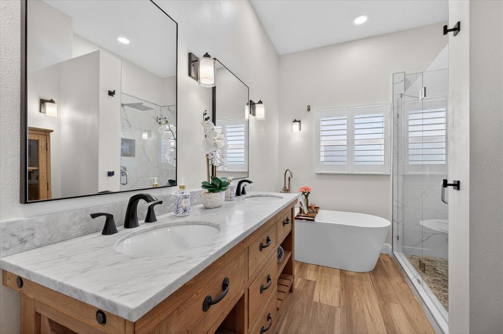 3339 Seaway Drive New Port Richey, FL 34652 - Photo 24 of 74 a bathroom with a sink double vanity granite tub and shower