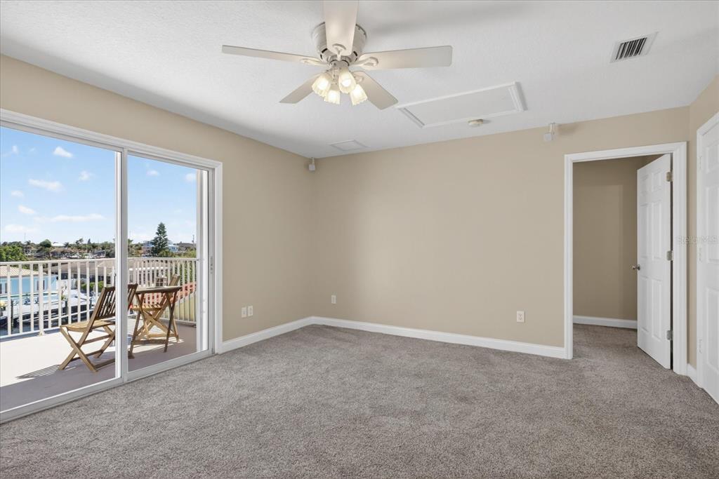 3339 Seaway Drive New Port Richey, FL 34652 - Photo 30 of 74 an empty room with chandelier fan and windows