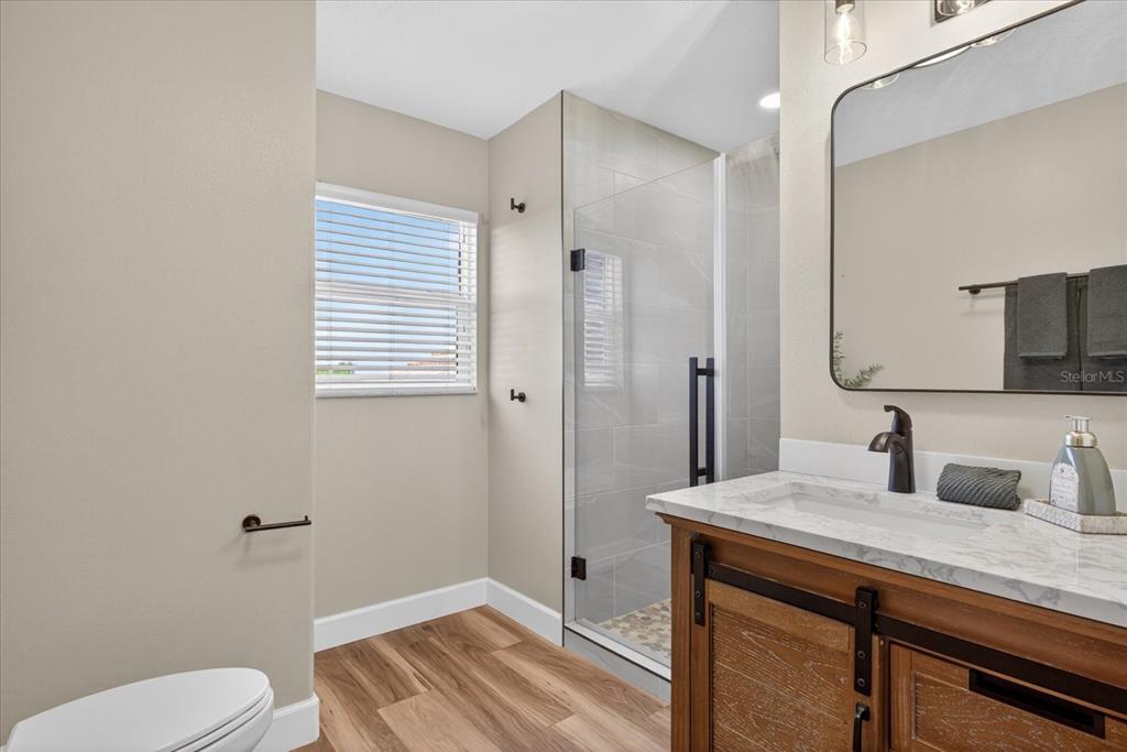 3339 Seaway Drive New Port Richey, FL 34652 - Photo 35 of 74 a bathroom with a granite countertop sink toilet and shower