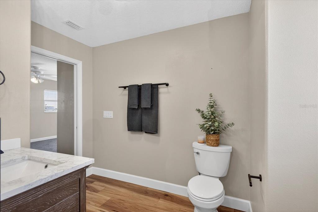 3339 Seaway Drive New Port Richey, FL 34652 - Photo 37 of 74 a bathroom with a toilet a sink and mirror