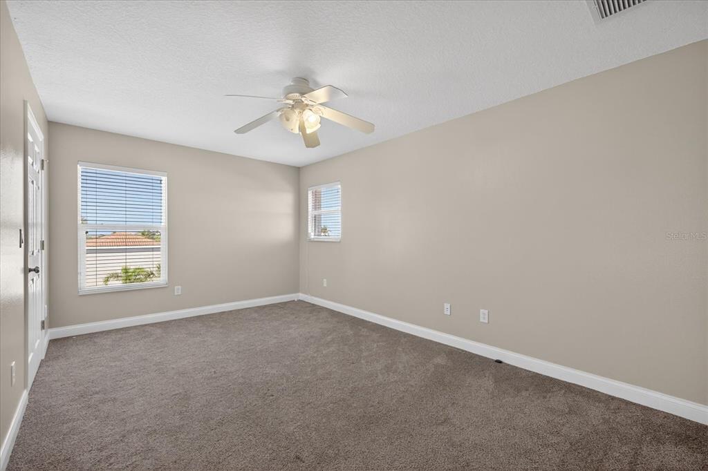 3339 Seaway Drive New Port Richey, FL 34652 - Photo 38 of 74 an empty room with windows and fan