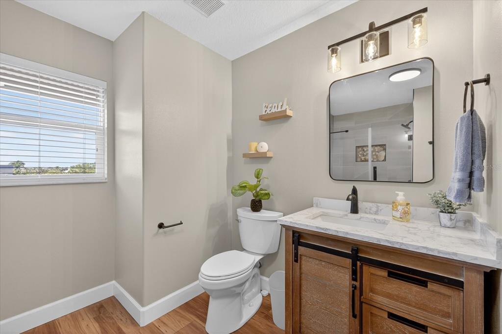 3339 Seaway Drive New Port Richey, FL 34652 - Photo 43 of 74 a bathroom with a granite countertop toilet sink and mirror