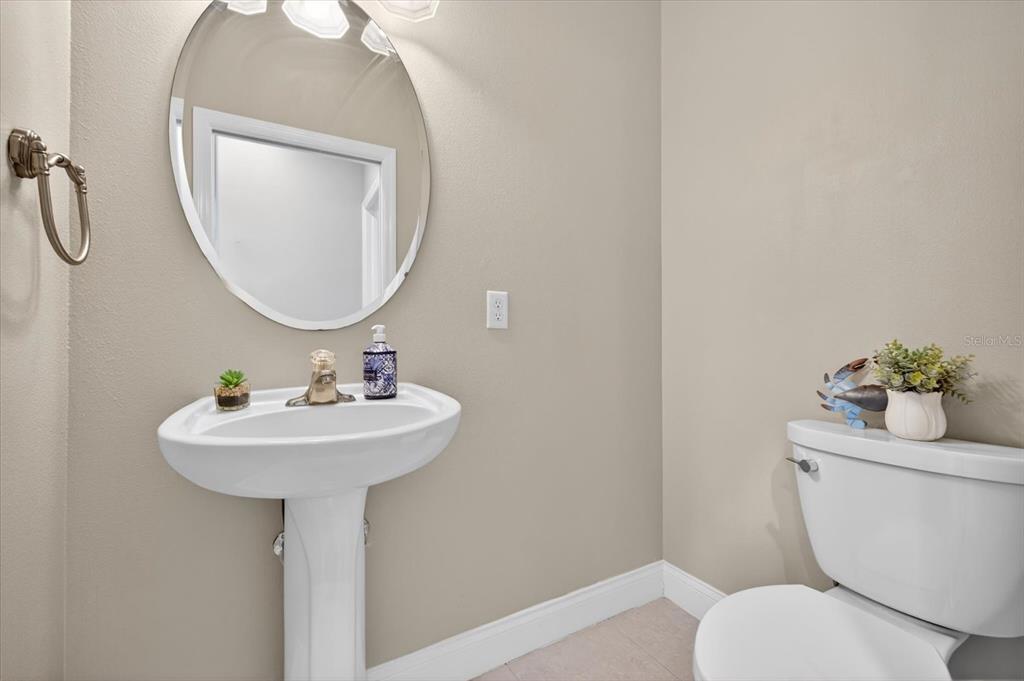 3339 Seaway Drive New Port Richey, FL 34652 - Photo 8 of 74 a bathroom with a toilet sink and mirror