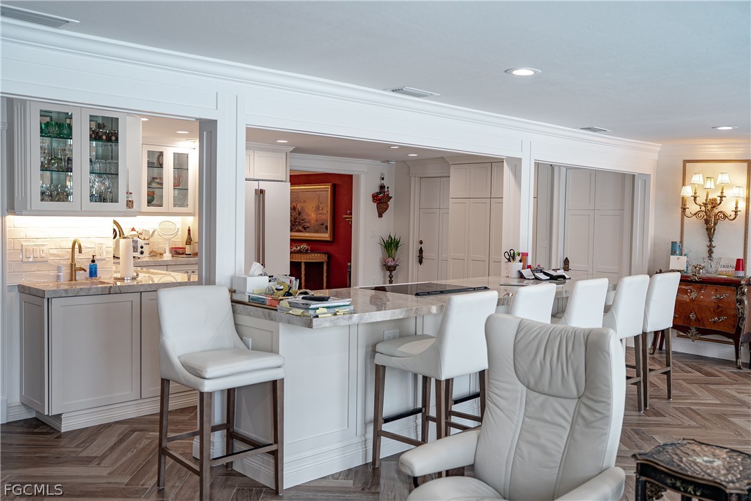 4902 Esplanade Street Estero, FL 34134 - Photo 15 of 40 a view of a dining room with furniture and wooden floor