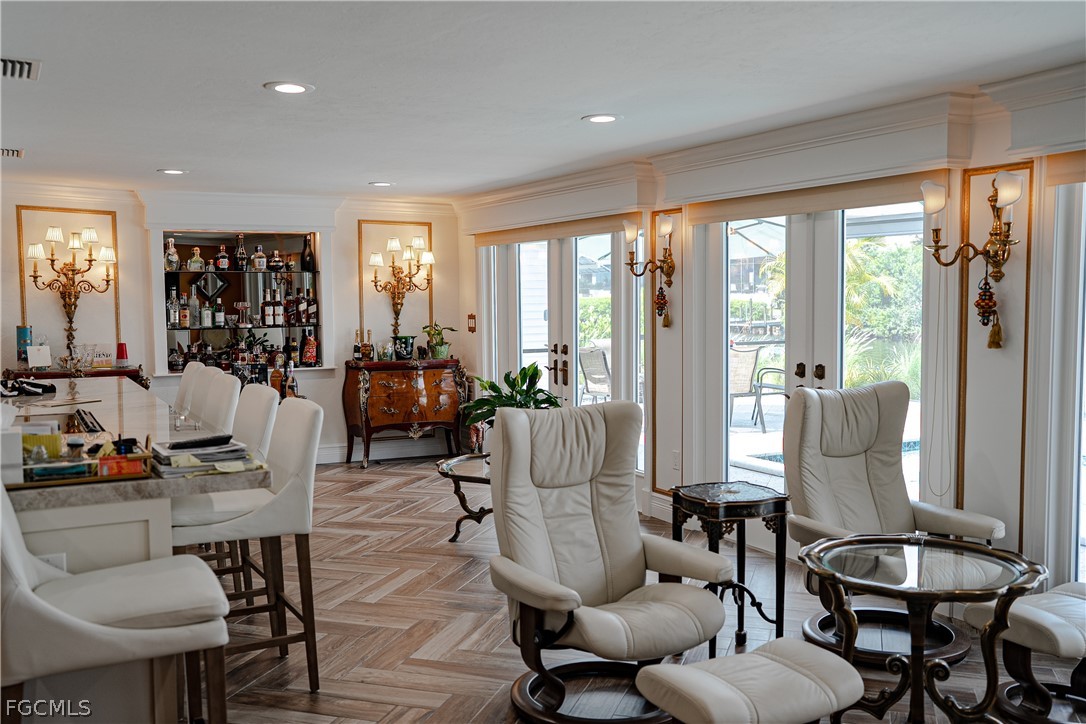 4902 Esplanade Street Estero, FL 34134 - Photo 17 of 40 a living room with furniture and floor to ceiling windows