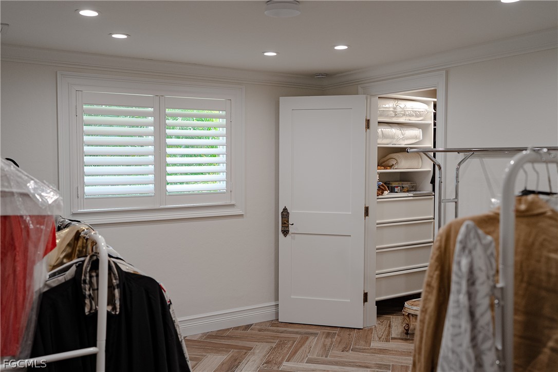 4902 Esplanade Street Estero, FL 34134 - Photo 20 of 40 a view of walk in closet with clothes and shoes