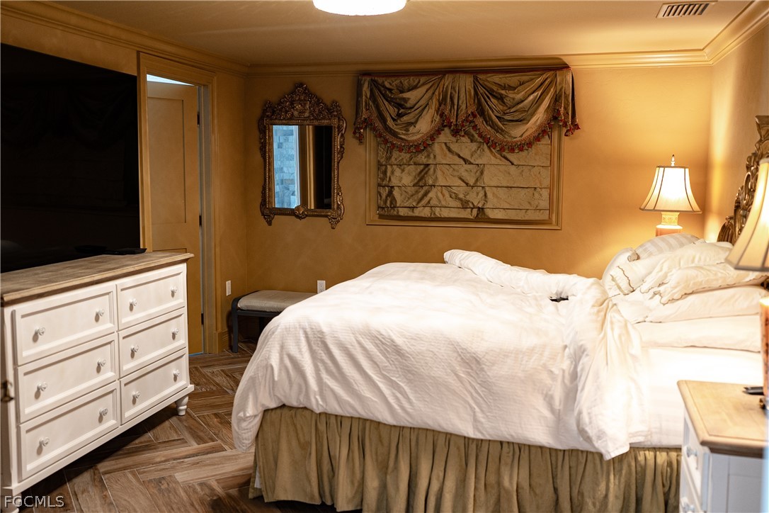 4902 Esplanade Street Estero, FL 34134 - Photo 21 of 40 a bedroom with a bed and furniture