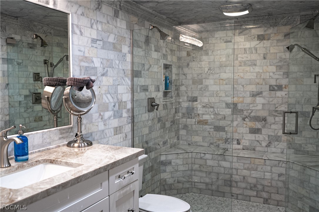 4902 Esplanade Street Estero, FL 34134 - Photo 22 of 40 a bathroom with a sink and a mirror