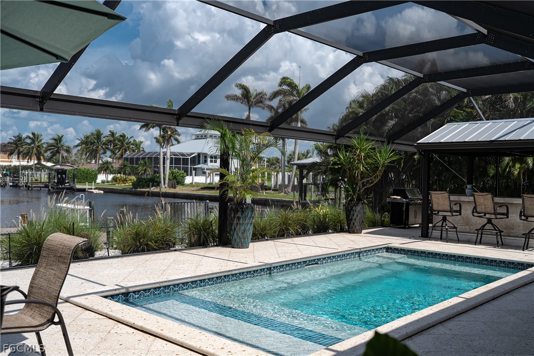 4902 Esplanade Street Estero, FL 34134 - Photo 28 of 40 a view of a swimming pool with a patio