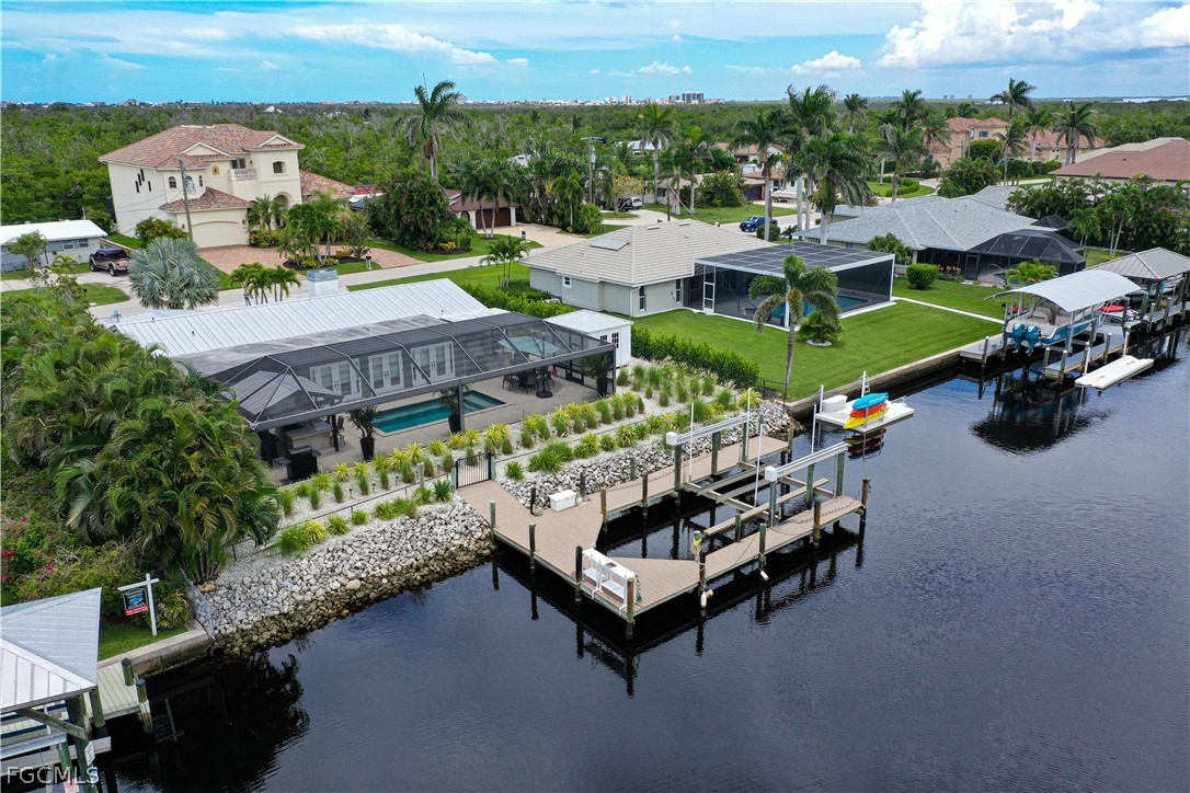 4902 Esplanade Street Estero, FL 34134 - Photo 36 of 40 an aerial view of a house with a garden and lake view