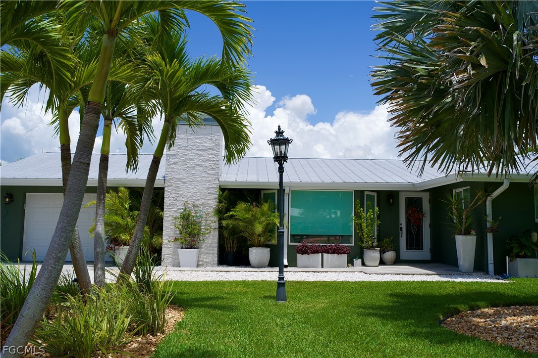 4902 Esplanade Street Estero, FL 34134 - Photo 5 of 40 a view of a house with a yard and plants