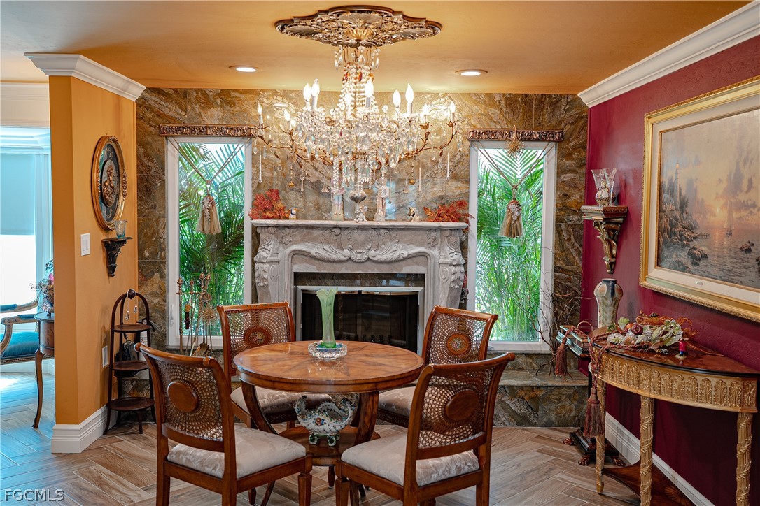 4902 Esplanade Street Estero, FL 34134 - Photo 9 of 40 a dining room with furniture a fireplace and chandelier