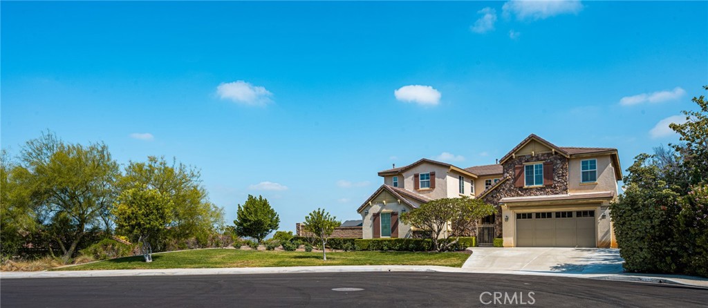 12652 Twin Peak Court Riverside, CA 92503 - Photo 3 of 55 a front view of a house with a yard and garage