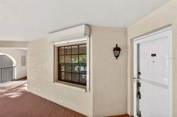 a view of an empty room with glass door