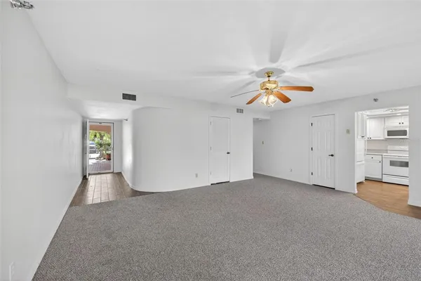 a living room with kitchen island furniture and a chandelier