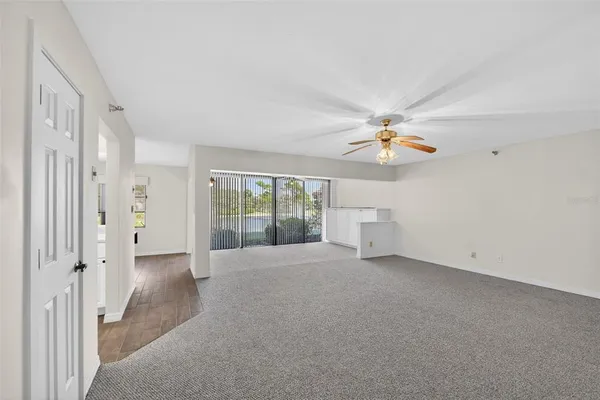 a living room with stainless steel appliances kitchen island granite countertop furniture and a fireplace