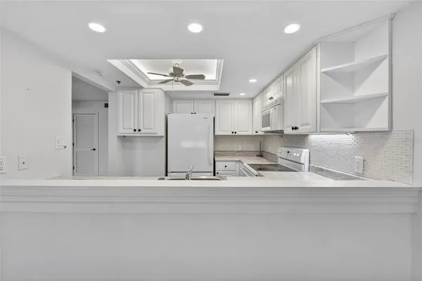 a bathroom with a glass door shower a sink and a mirror