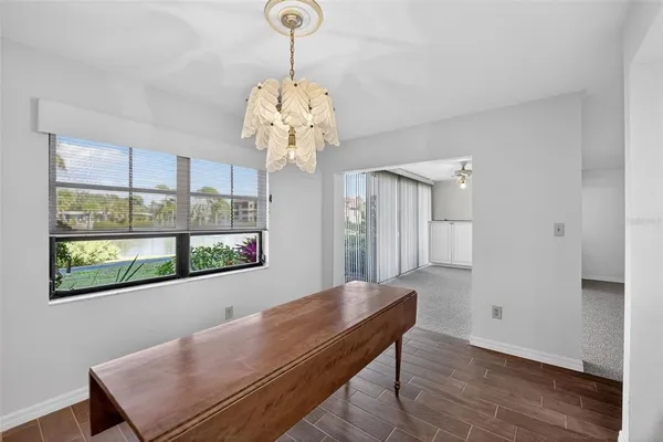 a view of an empty room with a chandelier fan