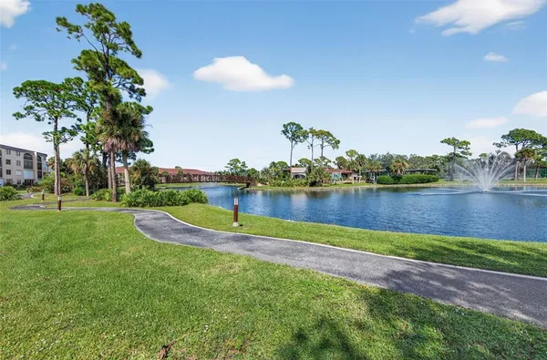 a view of a house with garden and a yard