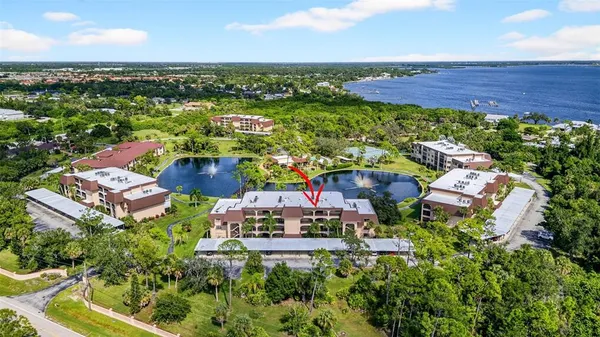 an aerial view of a house with a garden and lake view