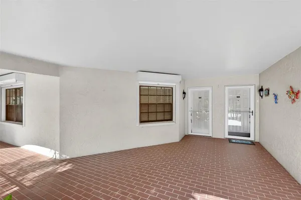 an empty room with closet and a chandelier fan