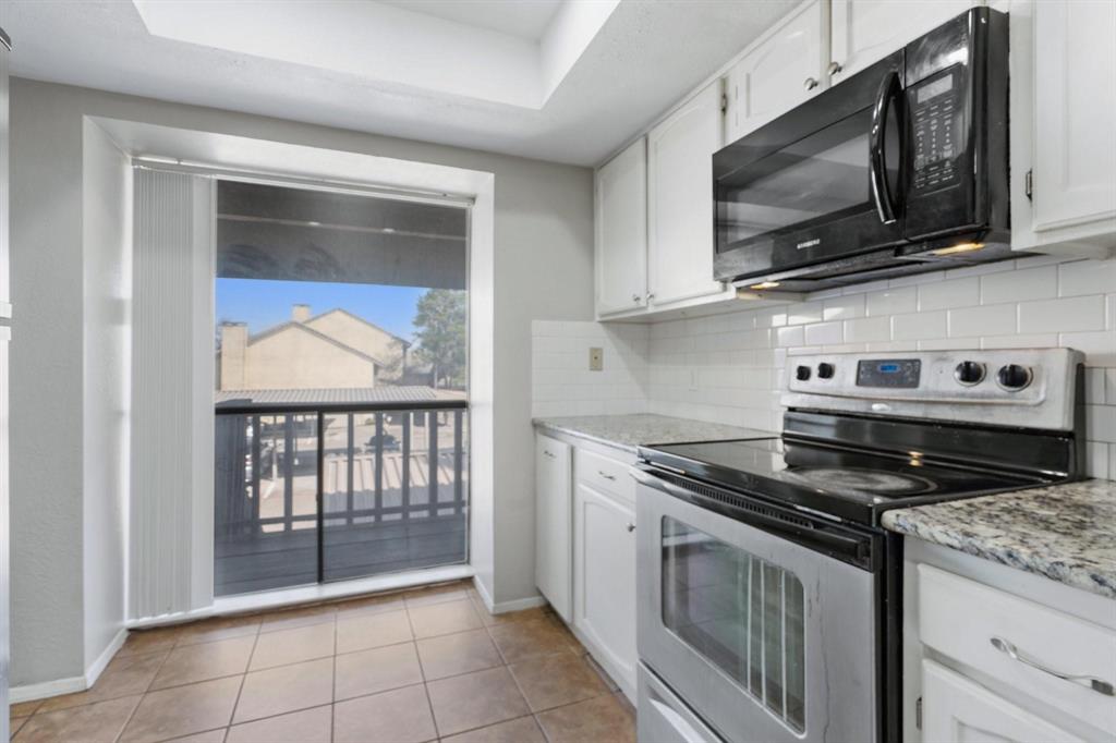4533 North O'Connor Road, Unit 2208 Irving, TX 75062 - Photo 12 of 28 a kitchen with stainless steel appliances granite countertop a stove microwave and sink
