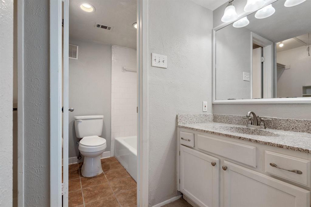 4533 North O'Connor Road, Unit 2208 Irving, TX 75062 - Photo 15 of 28 a bathroom with a granite countertop sink toilet and a mirror