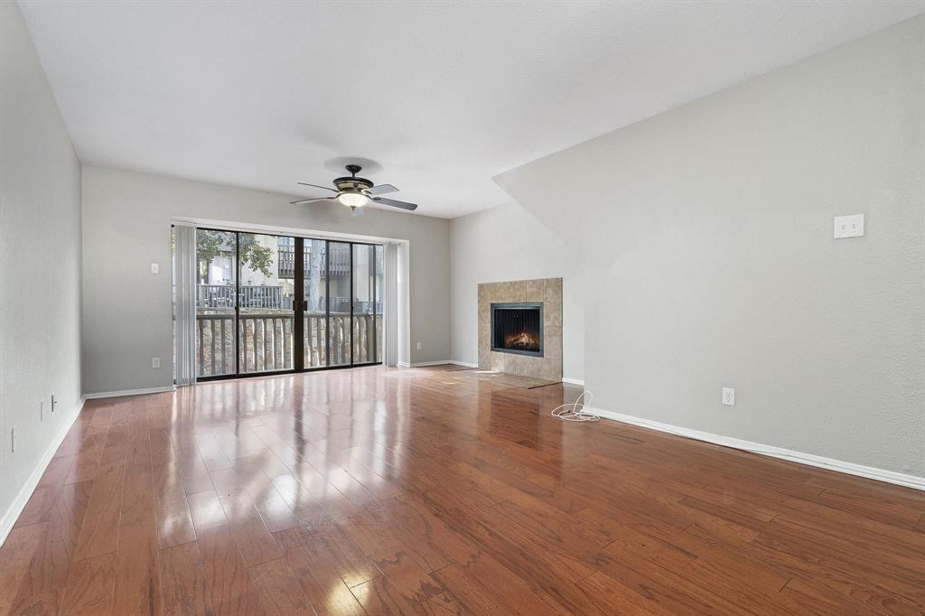 4533 North O'Connor Road, Unit 2208 Irving, TX 75062 - Photo 5 of 28 a view of an empty room with wooden floor and a window