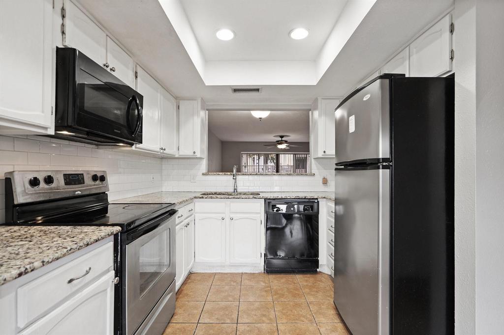 4533 North O'Connor Road, Unit 2208 Irving, TX 75062 - Photo 8 of 28 a kitchen with stainless steel appliances granite countertop a refrigerator stove and microwave